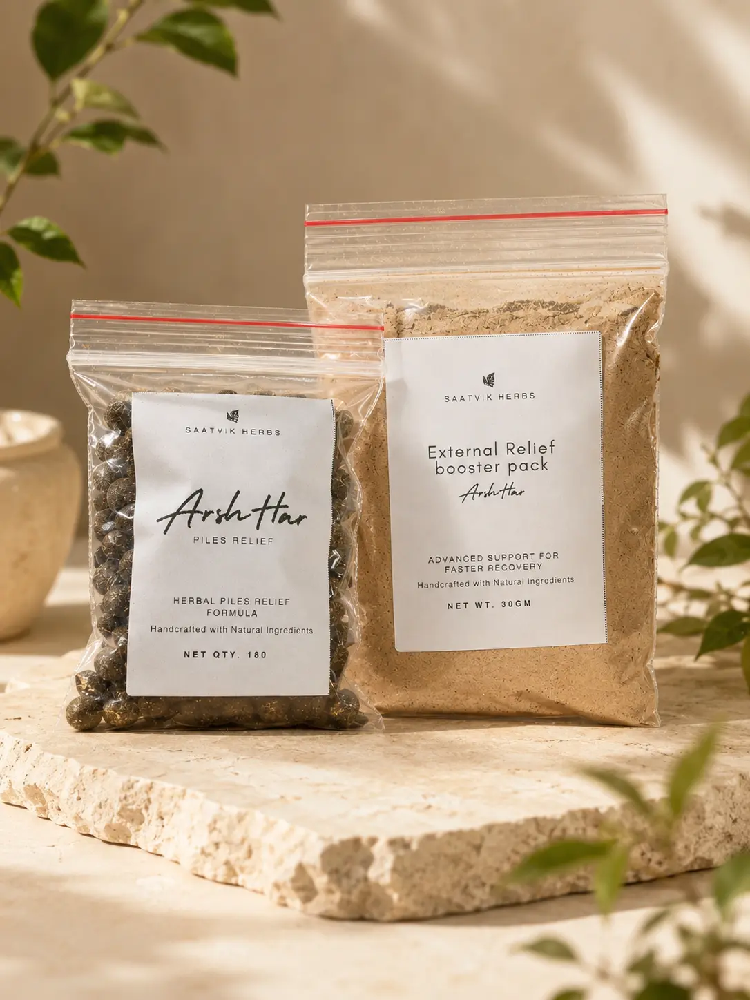 The ArshHar tablet pouch and the external booster pack together on a stone ledge in soft daylight